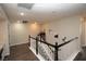 Upstairs hallway with dark hardwood floors and access to bedrooms at 10418 Prairie Mountain Ave, Las Vegas, NV 89166