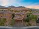 Two-story house with brick accents and a three-car garage, aerial view at 11952 Girasole Ave, Las Vegas, NV 89138