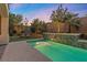 Luxury pool and spa with waterfall feature at sunset at 11952 Girasole Ave, Las Vegas, NV 89138