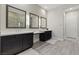 Double vanity bathroom with large mirrors and neutral tones at 11952 Girasole Ave, Las Vegas, NV 89138