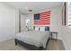 Bedroom with a striped bedspread and American flag at 11952 Girasole Ave, Las Vegas, NV 89138