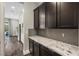 Butlers pantry with granite countertops and dark cabinets at 11952 Girasole Ave, Las Vegas, NV 89138