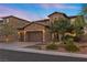 Two-story home with brick exterior, three-car garage, and landscaped yard at 11952 Girasole Ave, Las Vegas, NV 89138