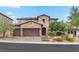 Two-story home with brick exterior, three-car garage, and landscaped yard at 11952 Girasole Ave, Las Vegas, NV 89138