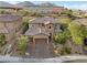 Two-story house with brick facade and three-car garage at 11952 Girasole Ave, Las Vegas, NV 89138