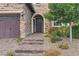 Brick front entrance with a three-car garage and stone steps leading to the door at 11952 Girasole Ave, Las Vegas, NV 89138