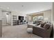 Comfortable living room with gray sectional sofa and access to a private balcony at 11952 Girasole Ave, Las Vegas, NV 89138