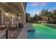 Evening view of a relaxing patio area next to a refreshing pool at 11952 Girasole Ave, Las Vegas, NV 89138