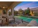 Sunset view of a relaxing pool and patio seating area at 11952 Girasole Ave, Las Vegas, NV 89138