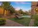 Private backyard with a refreshing pool, landscaping and lounge chairs at 11952 Girasole Ave, Las Vegas, NV 89138