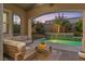 Evening view of a comfortable patio next to a sparkling pool at 11952 Girasole Ave, Las Vegas, NV 89138