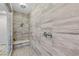 Large walk-in shower with gray tile and built-in seat at 11952 Girasole Ave, Las Vegas, NV 89138