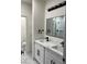 Modern bathroom with double vanity, black fixtures, and marble shower at 1308 E Nelson Ave, North Las Vegas, NV 89030