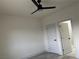 Bedroom with ceiling fan, light gray floors, and access to bathroom at 1308 E Nelson Ave, North Las Vegas, NV 89030