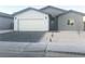 Modern gray and white single-Gathering home with a two-car garage and a neatly landscaped front yard at 1308 E Nelson Ave, North Las Vegas, NV 89030