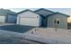 Gray and white exterior of a new single-story home with a two-car garage and landscaped yard at 1308 E Nelson Ave, North Las Vegas, NV 89030