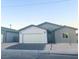 New construction home with gray and white exterior and two-car garage at 1308 E Nelson Ave, North Las Vegas, NV 89030