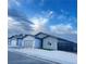 Street view of modern single-story homes featuring desert landscaping, gray and white exteriors, and secure gated entries at 1308 E Nelson Ave, North Las Vegas, NV 89030