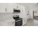 Bright kitchen featuring stainless steel appliances, modern white cabinetry, and stylish marble countertops at 1308 E Nelson Ave, North Las Vegas, NV 89030