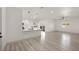 Spacious living room featuring light gray flooring, open to the modern kitchen, and bright natural light at 1308 E Nelson Ave, North Las Vegas, NV 89030