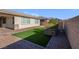 Artificial turf backyard with a retaining wall and landscaping at 131 Mosso Niente Pl, Henderson, NV 89011