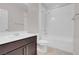 Bathroom with a shower/tub combo, dark brown vanity, and white tile at 131 Mosso Niente Pl, Henderson, NV 89011