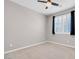 Bright bedroom with ceiling fan, neutral walls, and plush carpeting at 131 Mosso Niente Pl, Henderson, NV 89011