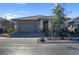 A charming single-story home features a well-manicured front yard, neutral paint, stone accents, and a paved driveway at 131 Mosso Niente Pl, Henderson, NV 89011