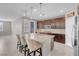 A modern kitchen features dark wood cabinets, stainless steel appliances, granite countertops, and an island with seating at 131 Mosso Niente Pl, Henderson, NV 89011