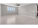 Living room featuring tile floors, large windows, and ceiling fan at 131 Mosso Niente Pl, Henderson, NV 89011