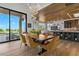 Bright dining room with large windows, wooden table, and stylish chairs at 2548 Faiss Dr, Las Vegas, NV 89134