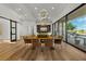 Elegant dining room with wood table, modern light fixture, and views at 2548 Faiss Dr, Las Vegas, NV 89134