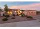 Beautiful home exterior at dusk featuring landscaping and a two-car garage at 2548 Faiss Dr, Las Vegas, NV 89134