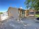 Tan house exterior with a covered patio and grassy backyard at 2604 Yardley St, Las Vegas, NV 89102