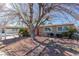 House exterior featuring a red door and large tree at 2828 Richfield Blvd, Las Vegas, NV 89102