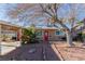 House exterior with red door, carport, and mature tree landscaping at 2828 Richfield Blvd, Las Vegas, NV 89102