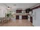 Bright kitchen with dark wood cabinets, tiled floor, and access to backyard at 2828 Richfield Blvd, Las Vegas, NV 89102