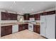 Kitchen with dark wood cabinets and white appliances at 2828 Richfield Blvd, Las Vegas, NV 89102