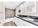 Updated bathroom with double vanity and wood-look tile floor at 3108 Emmons St, North Las Vegas, NV 89030