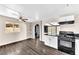 Modern kitchen with black appliances and wood-look flooring at 3108 Emmons St, North Las Vegas, NV 89030