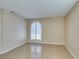 Bright bedroom featuring tile floors and arched window at 3150 Soft Breezes Dr # 2030, Las Vegas, NV 89128