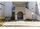 Condo building exterior with arched entryway and landscaping at 3150 Soft Breezes Dr # 2030, Las Vegas, NV 89128