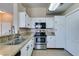 Modern kitchen with stainless steel appliances and white cabinets at 3150 Soft Breezes Dr # 2030, Las Vegas, NV 89128