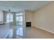 Living room with tile floors, fireplace and sliding glass door at 3150 Soft Breezes Dr # 2030, Las Vegas, NV 89128