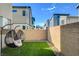 Private backyard with artificial turf and hanging chairs at 3354 Via Strada St, Henderson, NV 89044