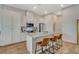 Modern kitchen with white cabinets, quartz countertops, and island at 3354 Via Strada St, Henderson, NV 89044