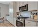 Stainless steel appliances and white cabinets in a modern kitchen at 3354 Via Strada St, Henderson, NV 89044