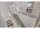 Upstairs hallway with modern railing and carpet at 3354 Via Strada St, Henderson, NV 89044