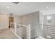 Upper level hallway with modern metal railing and carpet at 3354 Via Strada St, Henderson, NV 89044