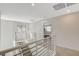 Upstairs hallway with modern metal railing and carpet flooring at 3354 Via Strada St, Henderson, NV 89044